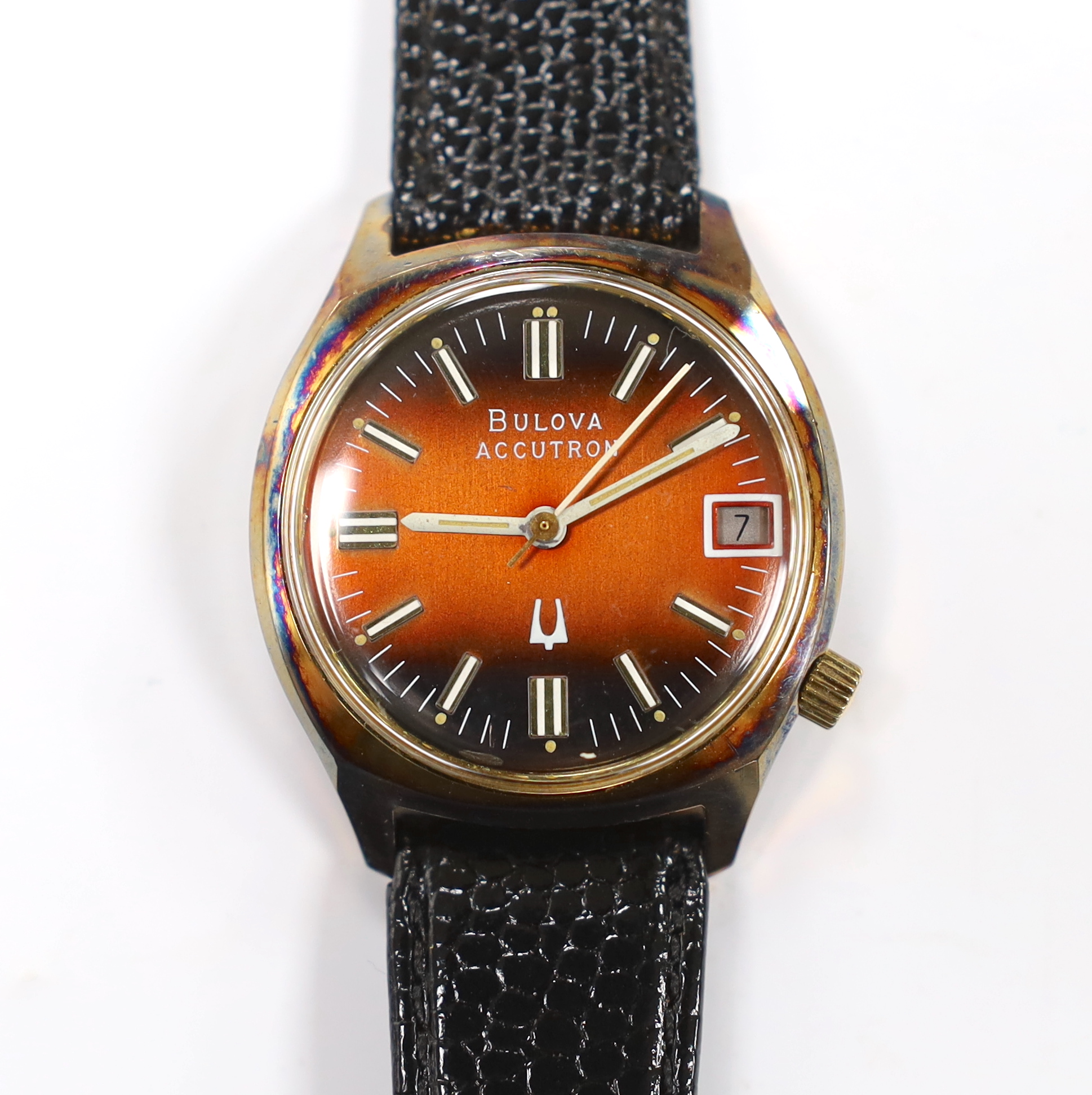 A gentleman's stainless steel and base metal Bulova Accutron wrist watch, with two tone dial, on a leather strap, case diameter 34mm.